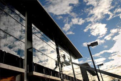 Workers at Spokane Falls Community College put the finishing touches along windows last week on the newest addition to the campus since the early 1990s. The nearly 70,000-square-foot building has large amounts of glass to provide a more expansive feel for light and space and a view of the forest. 
 (Brian Plonka / The Spokesman-Review)