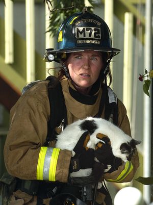 ORG XMIT: IDLEW102 Lewiston firefighter Laura Gifford rescues a cat from a house fire Wednesday, June 3, 2009 in Lewiston, Idaho.(AP Photo/Lewistion Tribune, Kyle Mills) (Kyle Mills / The Spokesman-Review)