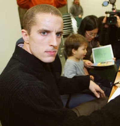 
Jeremy Hinzman, his son Liam and his wife, Nga Nguyen, wait for Canada's Refugee Board hearing to start in Toronto on Dec. 6.
 (File/Associated Press / The Spokesman-Review)