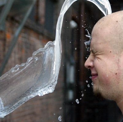 
Christian Specht waits for a splash of water from his  friends  to help cool off in 90-degree heat Wednesday in Wilkes-Barre, Pa. 
 (Associated Press / The Spokesman-Review)