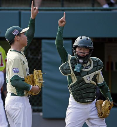 South Korea pitcher Moosung Kim, left, celebrates with catcher Junseo Cho after getting the final out of a 7-0 win over Mexico. (Gene J. Puskar / Associated Press)