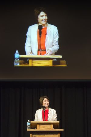 Congresswoman Cathy McMorris Rodgers’ image is projected above her as she addresses a crowd at a town hall meeting in August 2014.  (Dan Pelle / The Spokesman-Review)