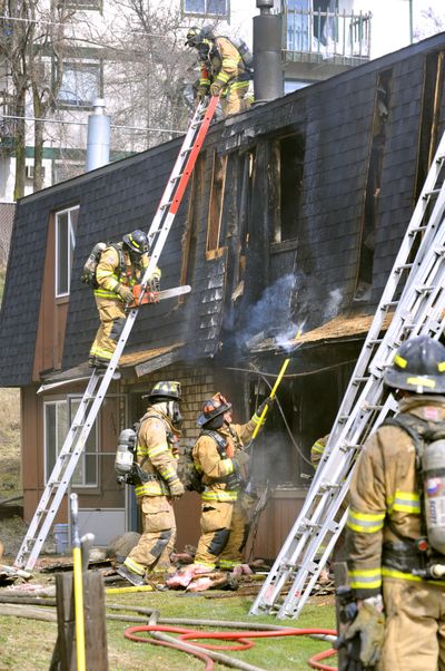 All residents safe: Spokane Fire Department firefighters mop up a blaze that damaged a triplex at 2524 N. Haven St. on Friday afternoon. Flames were showing as fire crews arrived, but they were able to contain the blaze to the middle unit without having to call a second alarm. All residents got out safely, and the fire is being investigated. (Colin Mulvany)
