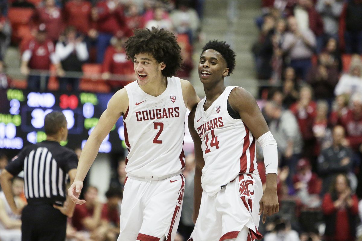 Washington State forward CJ Elleby (2) and guard Noah Williams (24) celebrate towards the end of their team