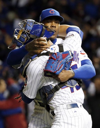 Chicago relief pitcher Aroldis Chapman and catcher Willson Contreras celebrate after the Cubs won Game 5 of the World Series on Sunday night, 3-2. (Nam Y. Huh / Associated Press)
