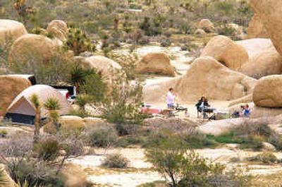 
Vacationers set up their campsites around granite boulders in Joshua Tree National Park located in Southern California's Mojave Desert. 
 (Associated Press / The Spokesman-Review)