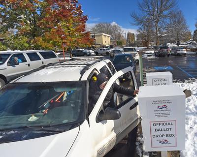 People came on foot and by car to drop off their election ballots at the North Spokane Library on Hawthorne Rd., Tuesday, Nov 8, 2022. At times there were upwards of 30 cars in line to drop off their ballots.  (Christopher Anderson/For The Spo)