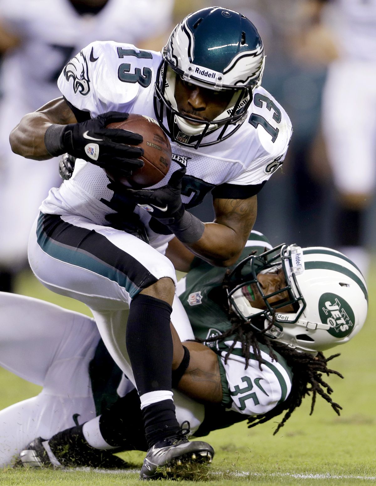 Former EWU standout Isaiah Trufant of New York Jets tackles Philadelphia wide receiver Damaris Johnson. He’ll face brother Marcus and the Seahawks in Seattle on Sunday. (Associated Press)