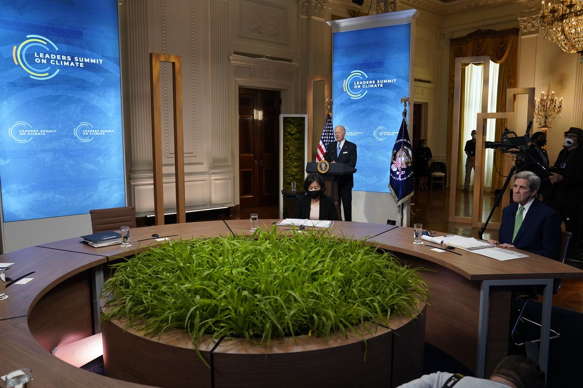 President Joe Biden speaks to the virtual Leaders Summit on Climate, from the East Room of the White House, Friday, April 23, 2021, in Washington, as Special Presidential Envoy for Climate John Kerry, looks on.  (Evan Vucci/Associated Press)