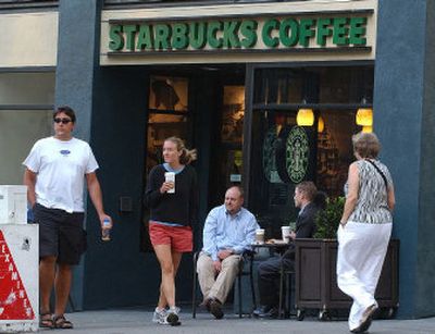 
Customers leave a Starbucks Coffee store while others relax outside in downtown San Francisco on Monday. Starbucks Corp.'s fiscal third-quarter profits soared nearly 30 percent, bolstered by strong U.S. and international sales, the company said Wednesday.
 (Associated Press / The Spokesman-Review)