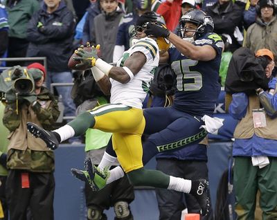 Green Bay’s Sam Shields (37) intercepts a pass in front of Jermaine Kearse of the Seahawks during the first half of Sunday’s game. (Associated Press)