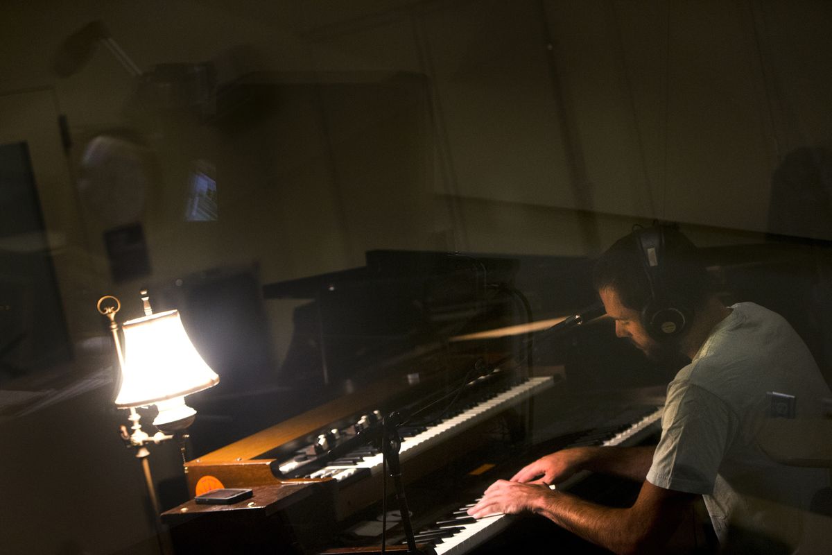 Folkinception frontman Matt Mitchell records a track during a session in early August at Spokane Falls Community College. (Tyler Tjomsland)