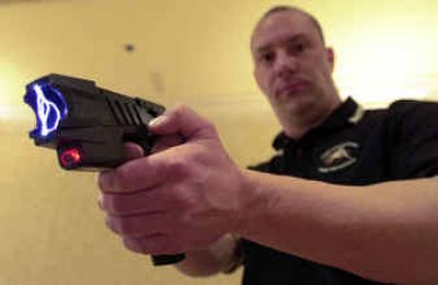 
Clay Winn, of Taser International, demonstrates the company's Advanced M-26 model in Las Vegas. Taser International Inc. won a $1.8 million contract to provide stun guns to military personnel, it was announced Wednesday.
 (File/Associated Press / The Spokesman-Review)