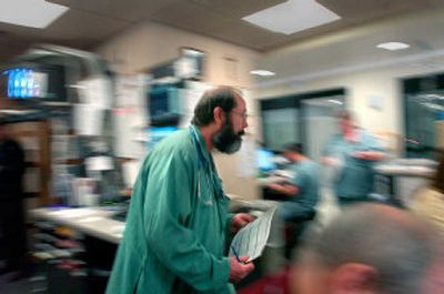 
Sacred Heart Emergency Department Charge Nurse Kevin Newman is in constant motion as he works the ebb and flow of patients coming to and leaving the hospital. 
 (Photos by Christopher Anderson/ / The Spokesman-Review)