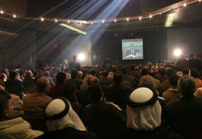 
Palestinians at the convention center in Gaza City watch Palestinian Authority President Mahmoud Abbas' speech  via video conference from Ramallah on Saturday. 
 (Associated Press photos / The Spokesman-Review)