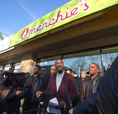 Byron Ragland, center, talks about being asked to leave a Menchie’s frozen-yogurt shop at a protest outside of the Kirkland business in November 2018. (Mike Siegel / Seattle Times)