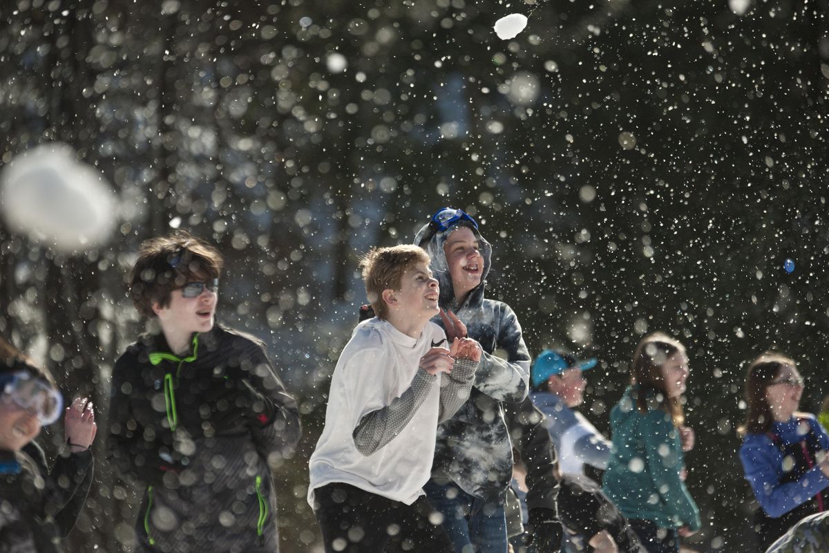 Scott Wilde, 14, left, James Bogdanowicz, 13, center, and Miles Kamara, 14, dodge snowballs during the first ever Coeur d