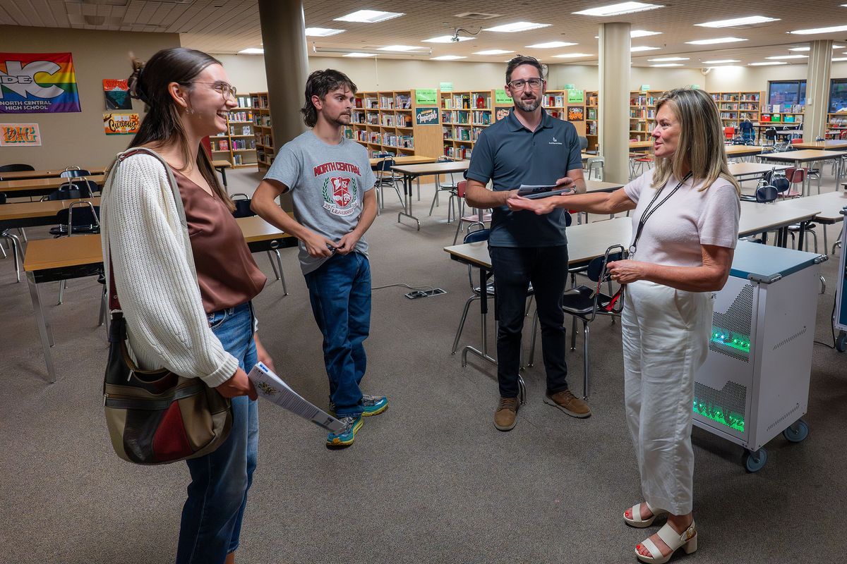 After a Spokane Public Schools town hall presentation, North Central High School Principal Tami McCracken, right, gives a tour of the school’s library to Helen Casey, left, Josh Olsen and Landon Defelice on Sept. 23 in Spokane. The library would be modernized if the school bond is passed in November. (COLIN MULVANY /THE SPOKESMAN-REVIEW)