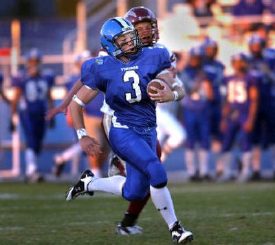 
Coeur d'Alene senior running back Cody Spencer streaks past University's Billy Moon for a 69-yard pass reception Thursday. 
 (Jed Conklin / The Spokesman-Review)