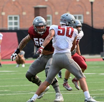 Washington State offensive tackle Jack Wilson, left, prepares to block edge rusher Lawrence Falatea during a spring practice in April at Rogers Field in Pullman. Wilson concluded his football career Saturday, then joined WSU’s basketball program.  (WSU Athletics)