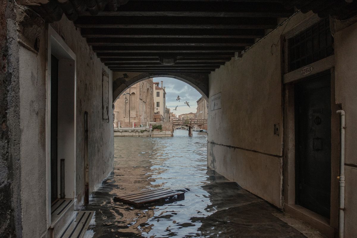 Floodwater laps at the entrances to two homes in central Venice, Italy on Nov. 19, 2022. As seas are predicted to continue to rise this century, officials fear the sea walls will have to be up constantly. (Laetitia Vancon/The New York Times)  (LAETITIA VANCON)