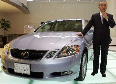 
Toyota Motor Co. President Katsuaki Watanabe unveils the Lexus GS450h rear-wheel drive hybrid vehicle, during a press conference Thursday in Tokyo. 
 (Associated Press / The Spokesman-Review)