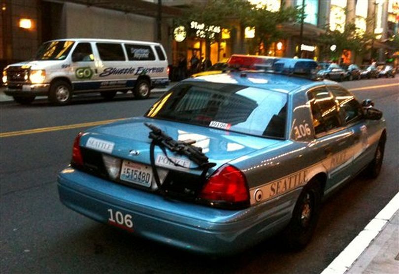 This handout photo provided by Nick Gonzalez for editorial purposes only, shows a police rifle left unattended on a patrol car outside a busy downtown area on Tuesday, June 28, 2011, in Seattle. A Seattle police spokesman says the department has launched an investigation into the incident. Rifles are assigned only to officers who have additional training and are usually kept in the trunk or between the driver and passenger seats. ((AP Photo/Nick Gonzalez))