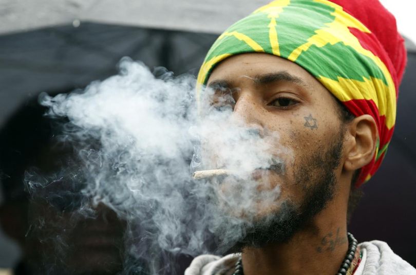 Jerome Waite, known by his spiritual name Rasfia, smokes a marijuana cigarette, during a rally to support the legalization of marijuana on Capitol Hill in Washington, Monday, April 24. (Alex Brandon / Associated Press)