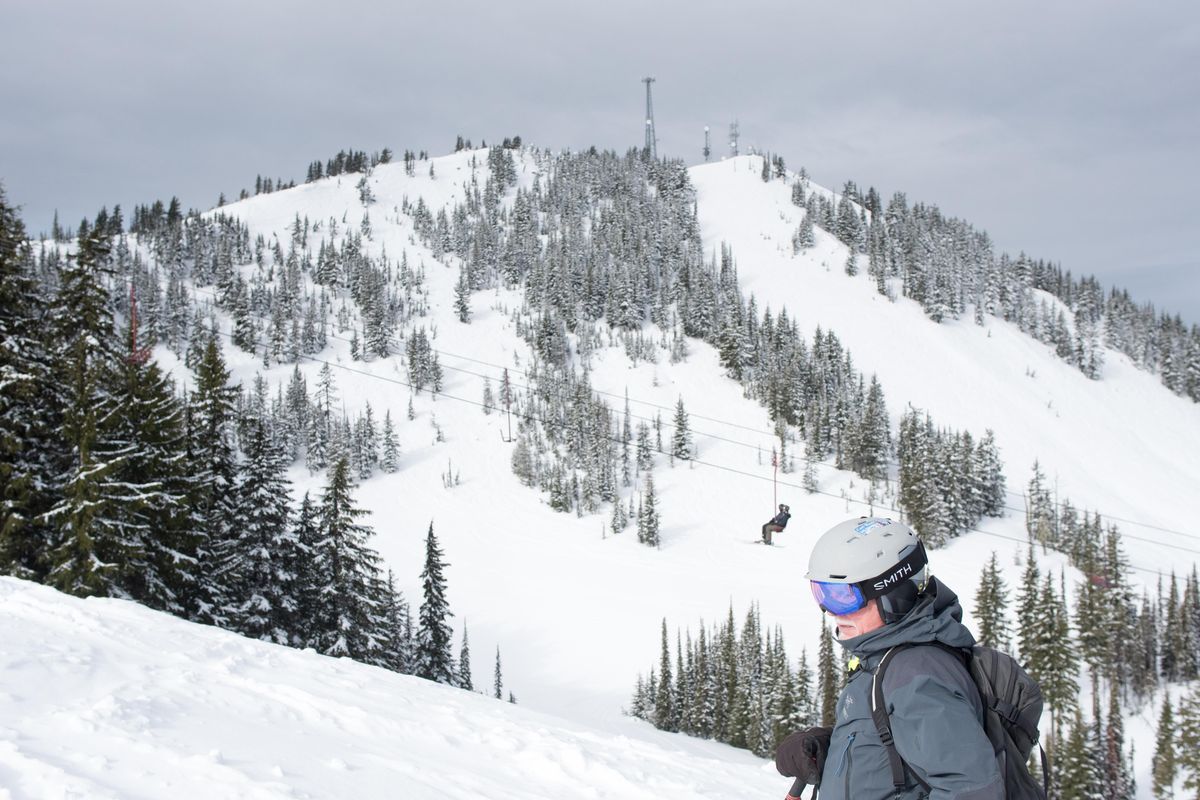 Bill Fuzak stands on Silver Mountain on March 10, 2020. In the background is the run 16-to-1, the run that an avalanche started on in January. (Eli Francovich / The Spokesman-Review)