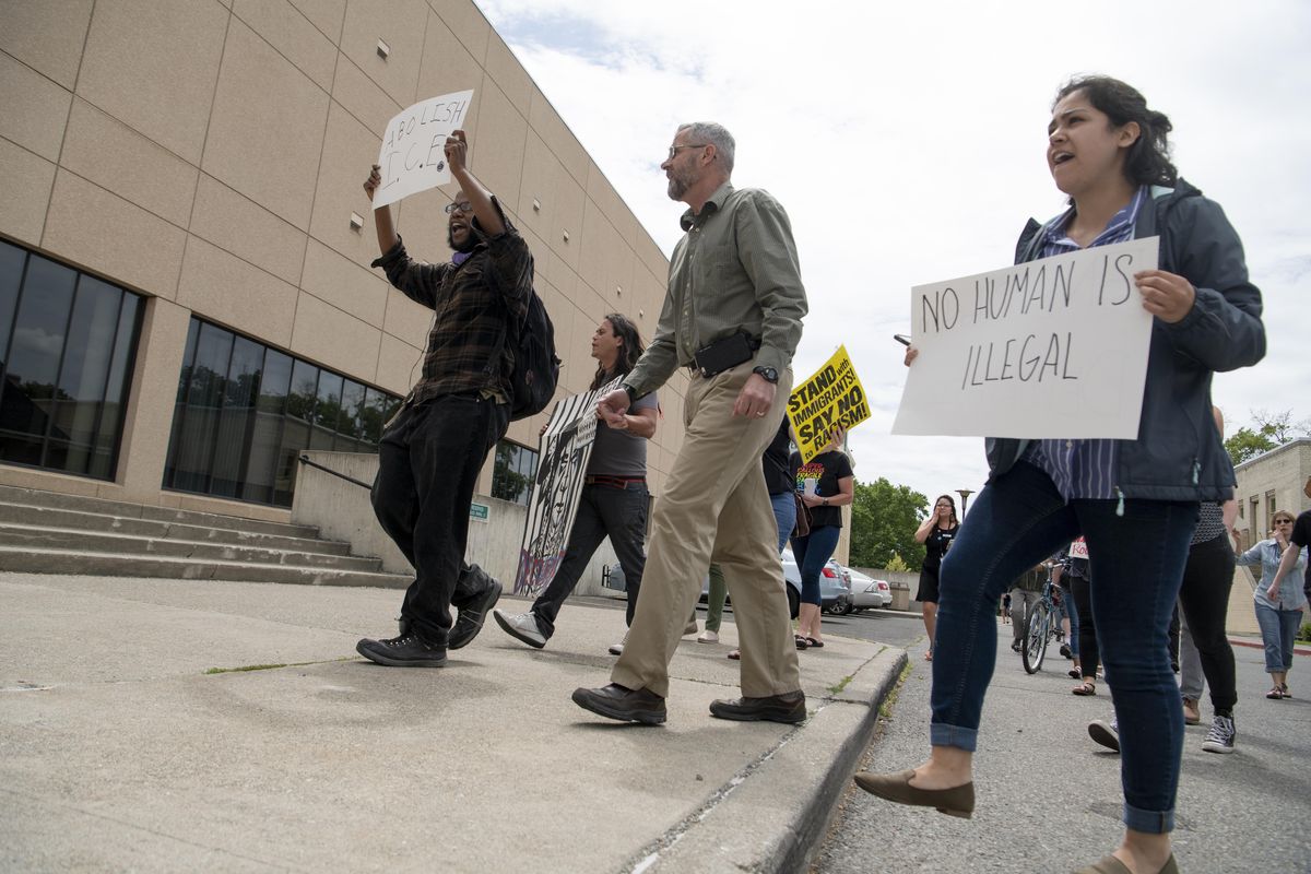 A group of approximately 30 protesters march around the Public Safety Building to the Spokane County Jail on Thursday, June 28, 2018 while decrying the detention of people charged with immigration crimes. (Jesse Tinsley / The Spokesman-Review)