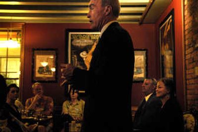 
Mayor Dennis Hession speaks Wednesday at a mayoral debate at Europa Pizza.   Fellow candidates Al French and Mary Verner, seated in the background, disagreed with Hession on the subject of developers' plans to remodel downtown low-income housing. 
 (Jed Conklin / The Spokesman-Review)
