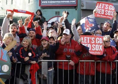 
Red Sox fans cheer outside Fenway Park in Boston on Monday, as they gather to greet the arrival of the team. Associated Press
 (Associated Press / The Spokesman-Review)