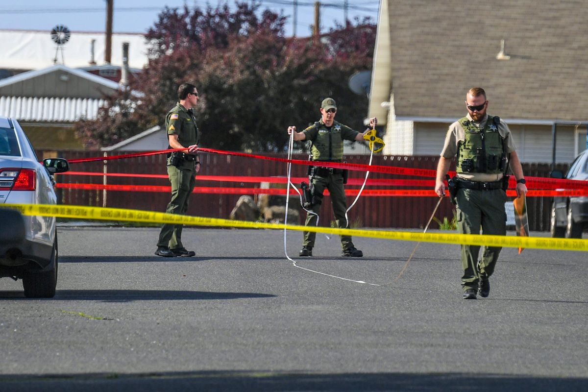Spokane County Sheriff’s deputies take measurements at the scene of a shooting Tuesday morning in Airway Heights that left one woman and her young daughter hospitalized.  (DAN PELLE/THE SPOKESMAN-REVIEW)