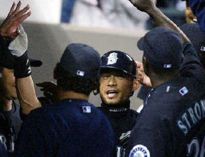 
Seattle's Ichiro Suzuki is greeted in the dugout after hitting a solo home run.
 (Associated Press / The Spokesman-Review)