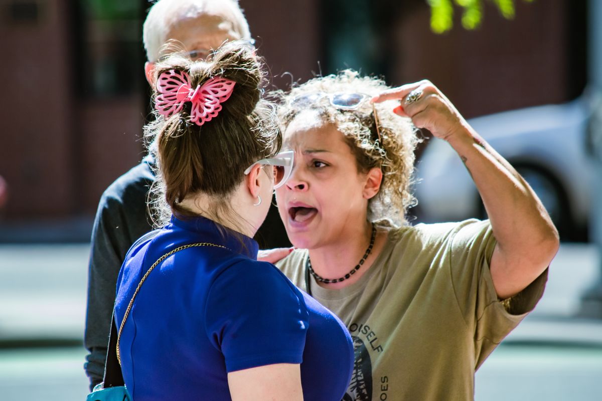 State Rep. Natasha Hill, D-Spokane, confronts Nicolette Ocheltree, a Democratic candidate for the legislature, about Ocheltree’s close association with Republican Jonathan Bingle on May 29 outside of a federal courthouse.  (Photo by Sandra Rivera)