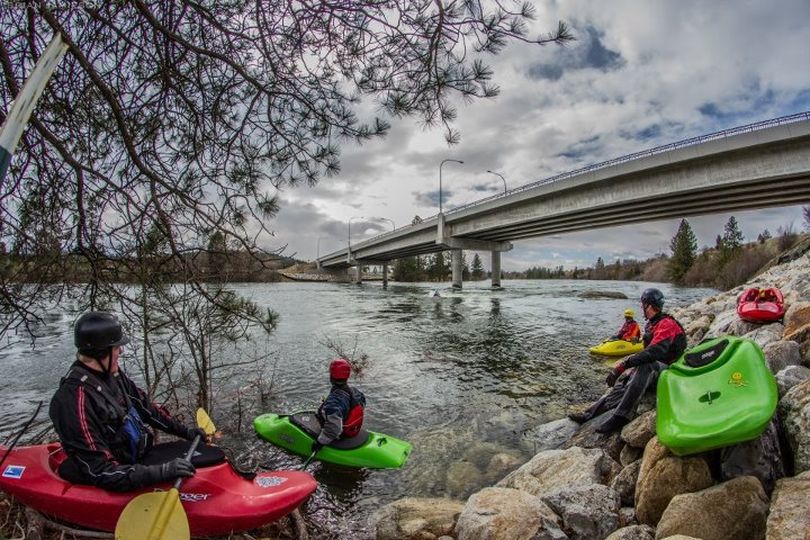 Kayakers stage to play in Dead Dog Hole on the Spokane River under the Stateline bridge. (Brian Jamieson)