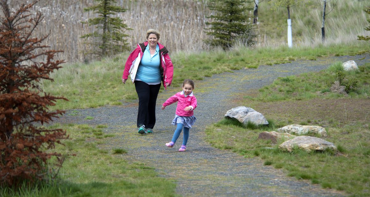 Carrie Day and her daughter, Chloe, 3, stroll through the Brown Mountain Regional Stormwater Facility. Carrie, age 40, has had both knees replaced since January. (Dan Pelle / The Spokesman-Review)