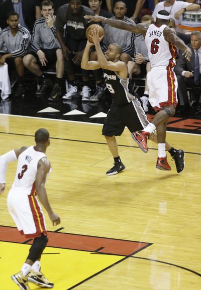 Spurs point guard Tony Parker makes a circus shot for the final points of the game. (Associated Press)