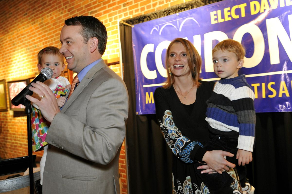 David Condon, with his wife, Kristin, and children Hattie, 16 months, and Creighton, 2, greet supporters at Barrister Winery after early results showed Condon with a lead over Spokane Mayor Mary Verner. (Colin Mulvany / The Spokesman-Review)