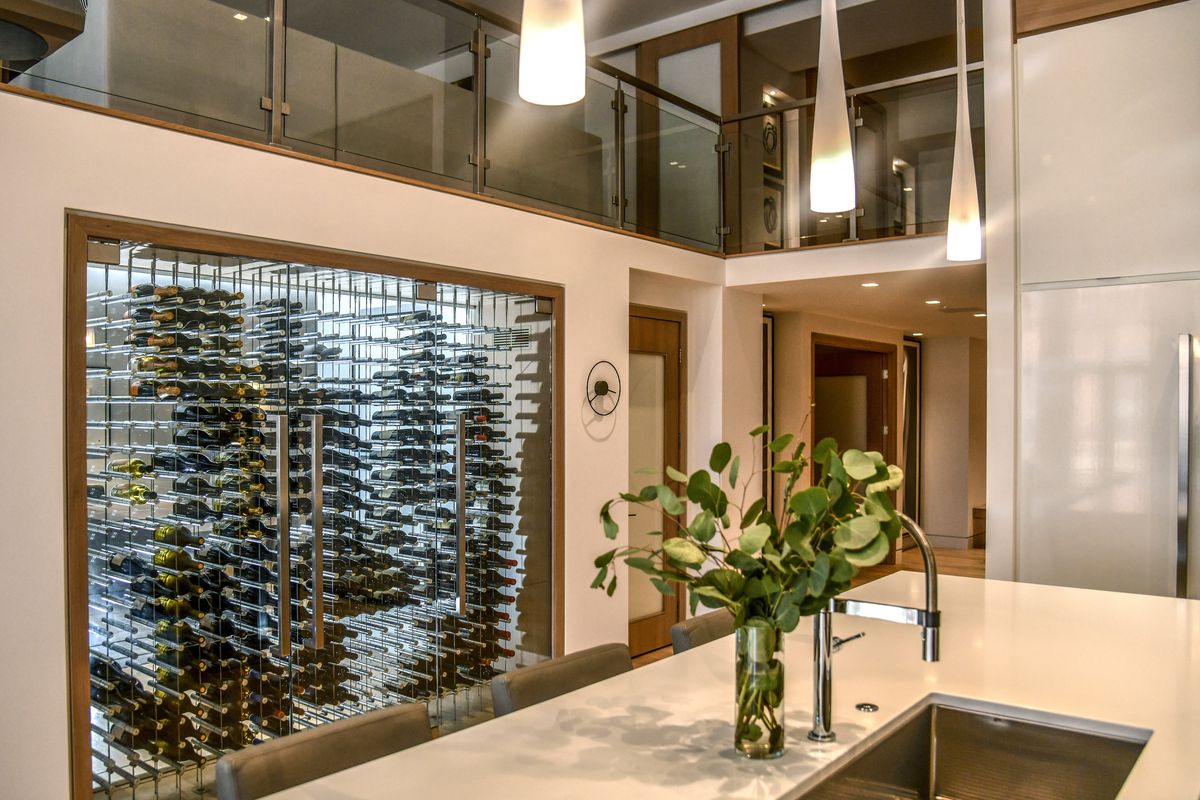 Spokane’s most expensive condo, which sold for $2.25 million, features a two-sided lighted glass climate control wine wall, left. The condo, which was designed by local interior designer Toni Brannon and built by Gunder Construction, is located in the former Burlington Coat Factory building above P.F. Chang’s in downtown Spokane.  (DAN PELLE/THE SPOKESMAN-REVIEW)