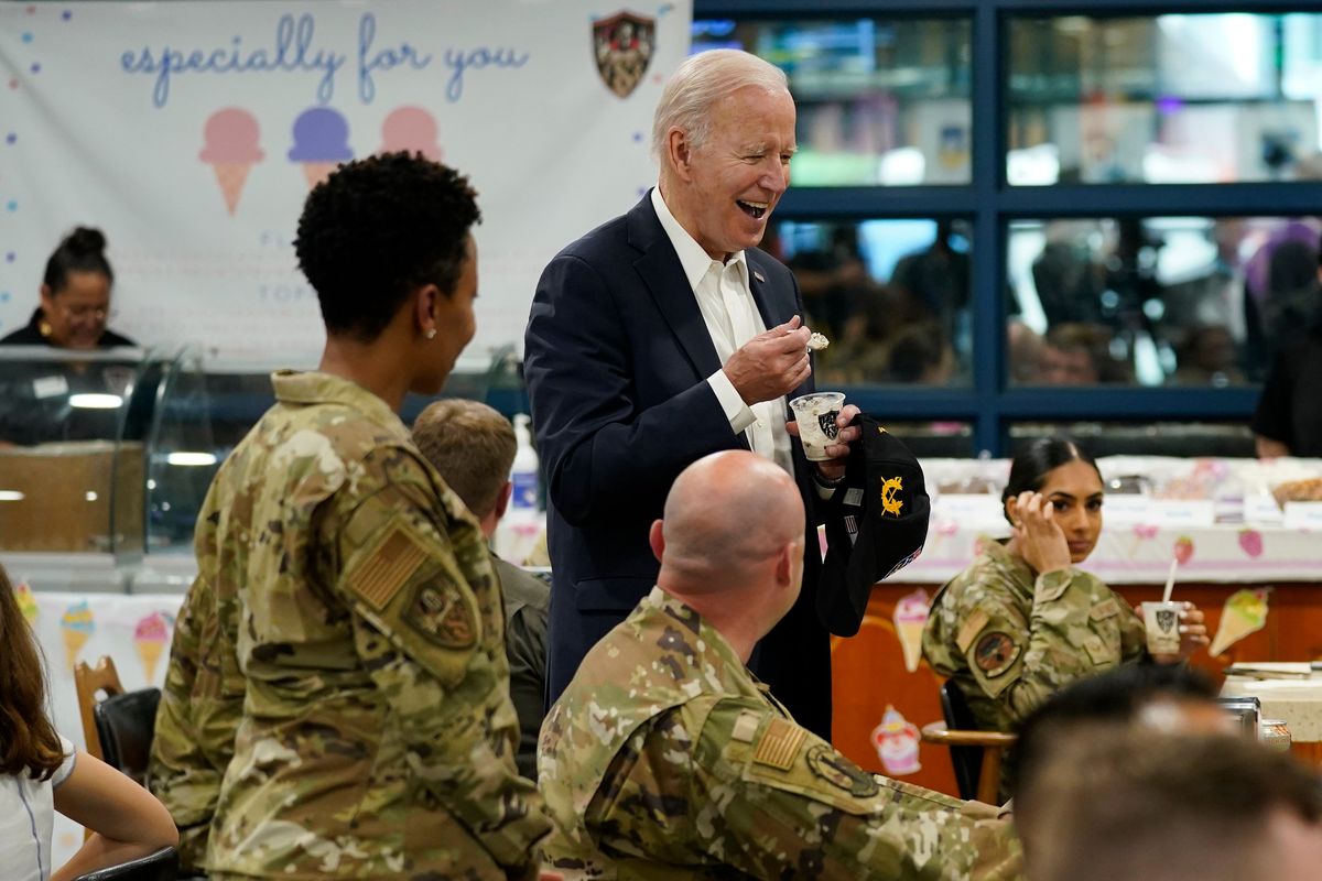 U.S. President Joe Biden eats ice cream as Biden meets with American service members and their family at Osan Air Base, Sunday, May 22, 2022, in Pyeongtaek, South Korea.  (Evan Vucci)