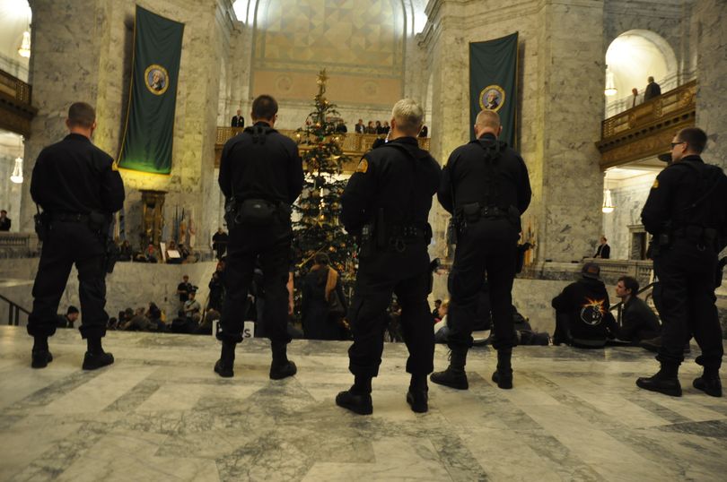 Washington State Troopers await orders to clear protesters from the Capitol Rotunda. (Jim Camden)