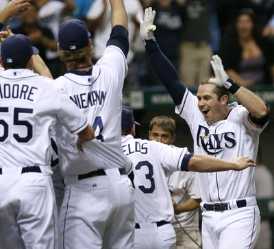 Rays’ Evan Longoria, right, celebrates with teammates after his 12th-inning walk-off homer clinched A.L. wild-card spot. (Associated Press)