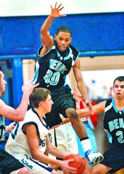
Central Valley's William Davis leaps to defend Gonzaga Prep's Michael Stockton. 
 (Brian Plonka / The Spokesman-Review)