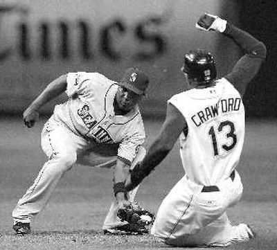 
Yuniesky Betancourt tags out Carl Crawford on steal attempt. 
 (Associated Press / The Spokesman-Review)