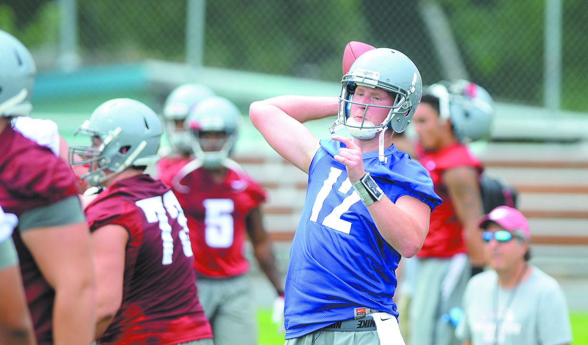 Cougars quarterback Connor Haliday works on passing drills. (Steve Hanks)