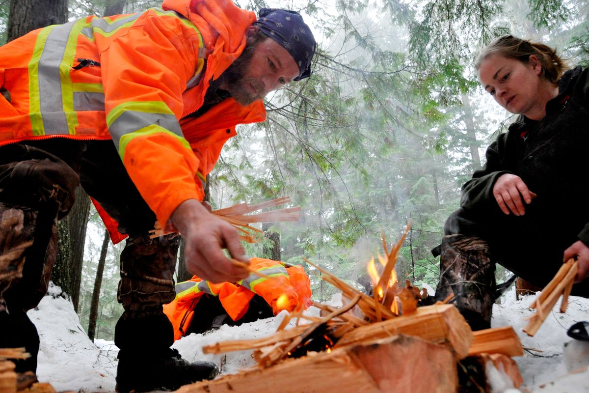Jimmy and Leah Driver of Bonners Ferry practice fire building during a January 2015 survival training session for the Priest Lake Search and Rescue volunteers.  (RICH LANDERS/FOR THE SPOKESMAN-REVIEW)