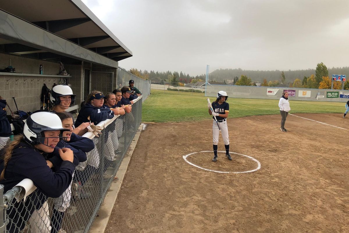 Mead’s bench looks on as coach Tiffany Casedy coaches third base during the Panthers’ 12-2 win over Central Valley on Tuesday. (Dave Nichols / The Spokesman-Review)
