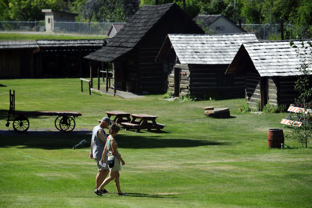 Pedestrians stroll through Pioneer Village in Cashmere, Wash. The complex features an outdoor collection of 20 original buildings, many built in the 1800s with fir logs skidded down from the hills.