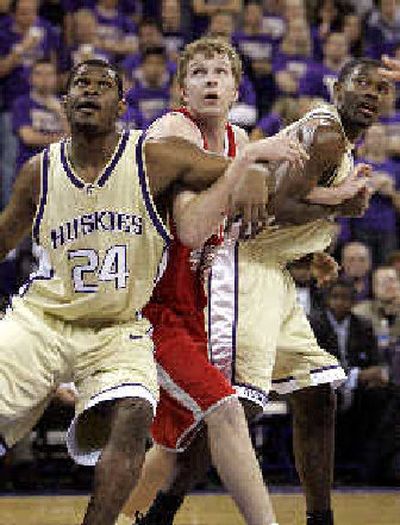 
Cornell's Andrew Naeve, center, is trapped by Jamaal Williams (24) and Bobby Jones. 
 (Associated Press / The Spokesman-Review)